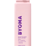 A pink bottle of BYOMA sensitive skin body lotion with white and purple text on the label.