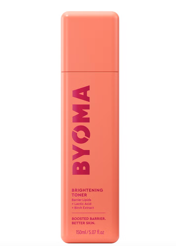 A pink spray bottle labeled 'BYOMA Brightening Toner' indicating a skin care product designed for brightening and barrier support.