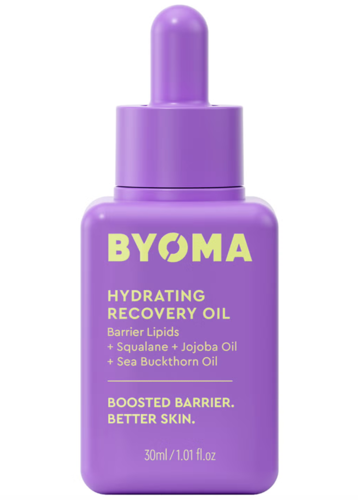 A purple bottle with a dropper cap labeled BYOMA Hydrating Recovery Oil, with details about the ingredients such as squalane, jojoba oil, and sea buckthorn oil.