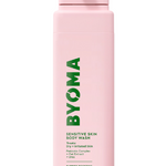 A pink bottle of BYOMA sensitive body wash with green and white text detailing the product name and description.