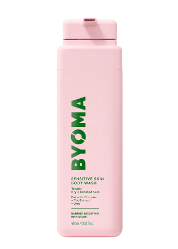 A pink bottle of BYOMA sensitive body wash with green and white text detailing the product name and description.
